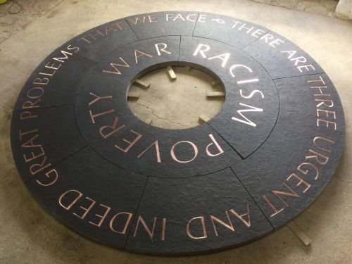 A surround of Bronze inset letters to a sculpture - by Nigel Boonham - of Martin Luther King , Newcastle University.